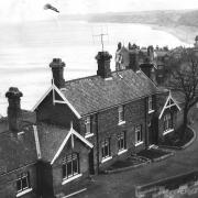 Sandsend railway station in 1962, four years after the railway closed, looking right round the bay to Whitby on the clifftop in the distance