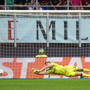 Nick Pope makes a save against AC Milan
