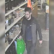 Police would like to speak to this man after a shopper indecently exposed himself to a cashier while attempting to pay for an item.