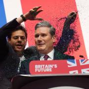 A protester throws glitter over and disrupts Labour leader Sir Keir Starmer