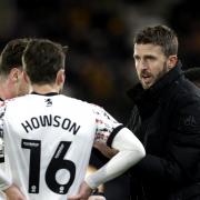 Michael Carrick has a touchline discussion with Jonny Howson