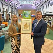 Peter Gibson MP presents the work of art to Darlington Library manager Suzy Hill