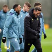 Callum Wilson shares a joke with Newcastle assistant Jason Tindall at training this morning