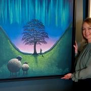 Artist Lucy Pittaway with the canvas of her painting of the Sycamore Gap tree