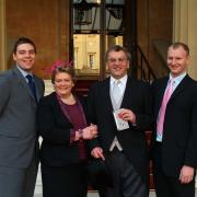 GONG SHOW: Mike Amos, with wife Sharon, and sons Adam, left, and Owen, after collecting his MBE