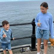 Grace and Harry Liddle getting ready to throw their bottles off the pier
