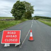 A road closure sign at the scene
