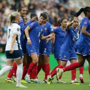 Elisa de Almeida (centre) leads the celebrations after scoring France's opening goal in their 2-1 win over England