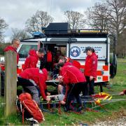 Mountain recue team assist an injured male with injured leg