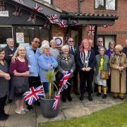 Guests, residents and staff gather outside Sycamore Hall Care Home for the unveiling of their “Veteran Friendly Care Home” plaque