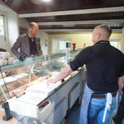 The Prince of Wales speaks to butchers during a visit to the the village of Bainbridge in North Yorkshire