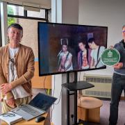 Cllr Phil Eames (right) with historian Ian Trowell (left) and a photo of the Sex Pistols on stage