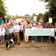 Members of Dishforth Residents' Group show their opposition to the housing plan.