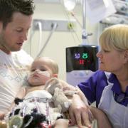 Kept Alive: 18-month-old Scarlett Ungurs, who needs a new heart, with dad Darren, and transplant co-ordinator Lynne Holt