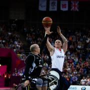 HOOP DREAMS: Terry Bywater, from Redcar, shoots for a basket under pressure from Germany’s iDirk Passiwan during Great Britain’s defeat at the North Greenwich Arena last night