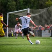 Dylan Stephenson sends over a cross in Darlington's defeat to King's Lynn