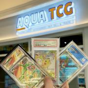 Rare and graded Pokémon trading cards on display outside Aqua TCG as collectors celebrate Pokémon's 30th anniversary at Metrocentre.