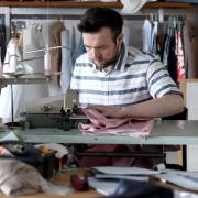 AT WORK: Phil Woodhead tidies seams on an overlocking machine