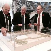 Business Secretary, Vince Cable, and Transport Secretary, Patrick McLoughlin and Alistair Dormer, Hitachi Rail Europe's executive chairman and chief executive, look at a model of the plant
