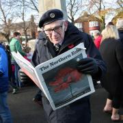 D-Day veteran Frank Huges reads a copy of The Northern Echo's Remembrance Sunday special edition