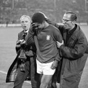Portugal's Eusebio being consoled by a compatriot as he leaves the field in tears after Portugal had been defeated 1-2 by England in the 1966 World Cup semi-final at Wembley.