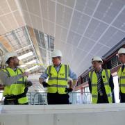 David Cameron speaks to apprentices at an office construction site during a 'Cameron Direct' event in Leeds