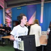 QUICK RETURN: A runner brings in the first ballot box to the Sunderland Tennis Centre as counting commences