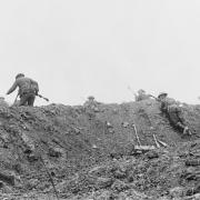 ATTACK: British soldiers go over the top from a shallow assembly trench during the Battle of the Somme. Picture courtesy of the Imperial War Museum