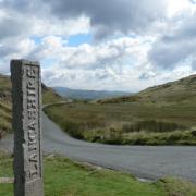 Three Shires Stone at Wrynose Pass.