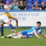 Aaron Cunningham slides in for a challenge whilst playing for Hartlepool United.