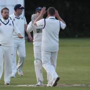 Martons' Matthew Connelly celebrates with his team mates after getting Marske's Craig Gratton LBW