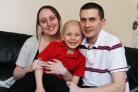 SMILE OF A FIGHTER: Leukaemia sufferer Cobie Woods with parents Deborah and Ross