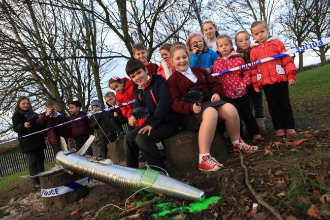 Pupils from St Wilfrid’s RC Primary School, Bishop Auckland, investigate UFO crash landing in school field pictured front Nathan Slater, 9, and Olivia Thompson, 9.