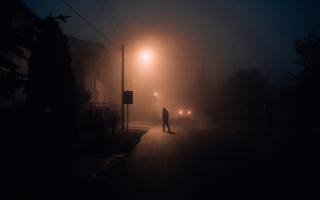 Anonymous figure walking in the night. Credit: Canva
