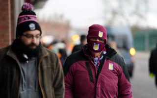 Fans walk away from the stadium following the news that Aston Villa's match against Burnley at Villa Park which has been postponed. Credit: PA