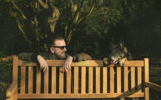 Undated handout photo issued by Netflix of Ricky Gervais and Brandy by a bench, Netflix has donated 25 benches to local councils around the UK as part of a mental health initiative celebrating the launch of the new series of Ricky Gervais' After Life.