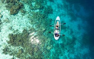People kayaking in the Maldives. Credit: Canva