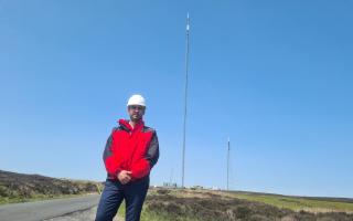 Shuja Khan, chief executive at Arqiva, in front of the new mast