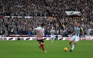Sean Longstaff plays a forward pass in front of the travelling hordes of Newcastle United fans