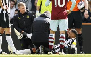 Jamaal Lascelles receives treatment on the pitch during Newcastle's win over West Ham