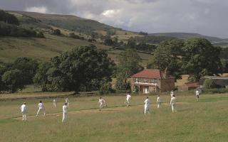 REMARKABLE: The tiny Spout House cricket ground, where grazing sheep have to be driven off before every match, has been named among the world’s greatest in a new lavish book Picture: JILL MEAD