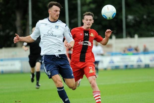 Jake Lawlor, pictured in action for Guiseley, has signed a new contract at Darlington.