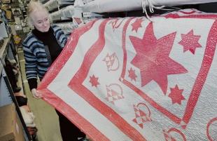 TREASURES: Senior Keeper Rosemary Allan takes a look at a quilt from 1900 which was donated by a family from Maiden Law