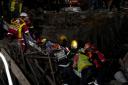A survivor is bought to the surface at the scene of a building collapse in the city of George, South Africa (Nardus Engelbrecht/AP)